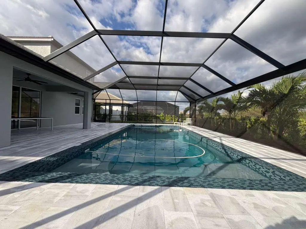 Beautiful fiberglass pool installation with clear blue water and modern landscaping